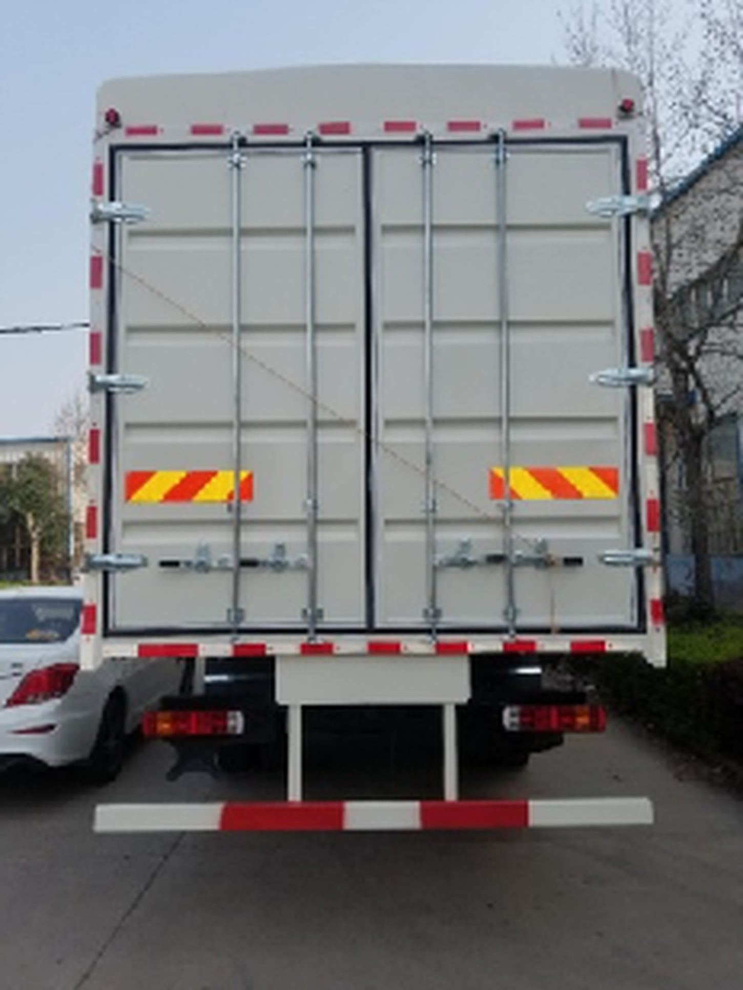 Rear view of a truck with closed gray cargo doors